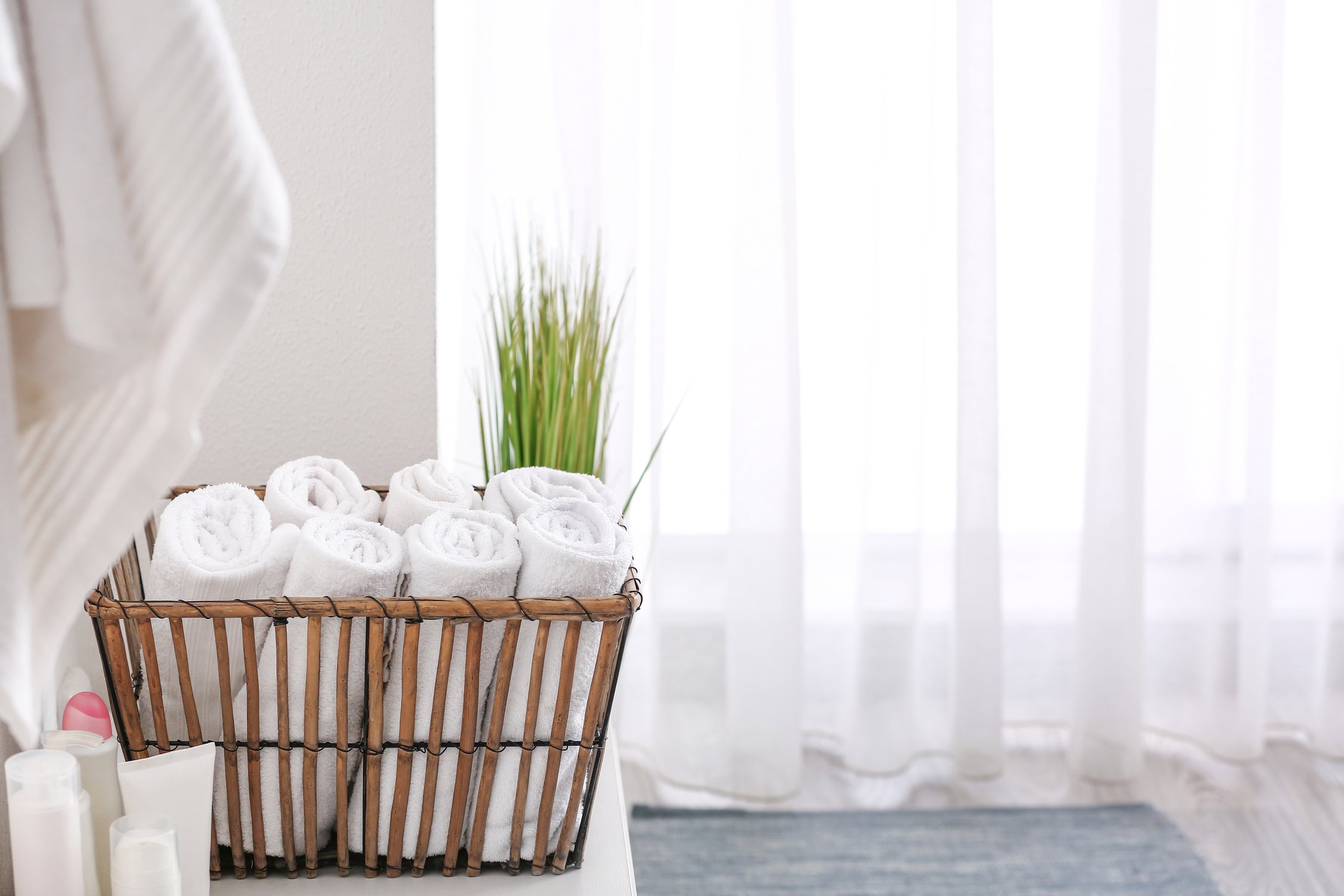 Basket with Clean Towels in Bathroom