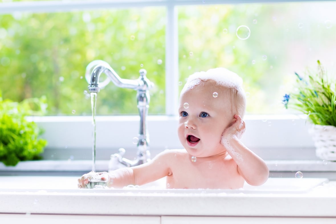 Sweet little baby taking bath