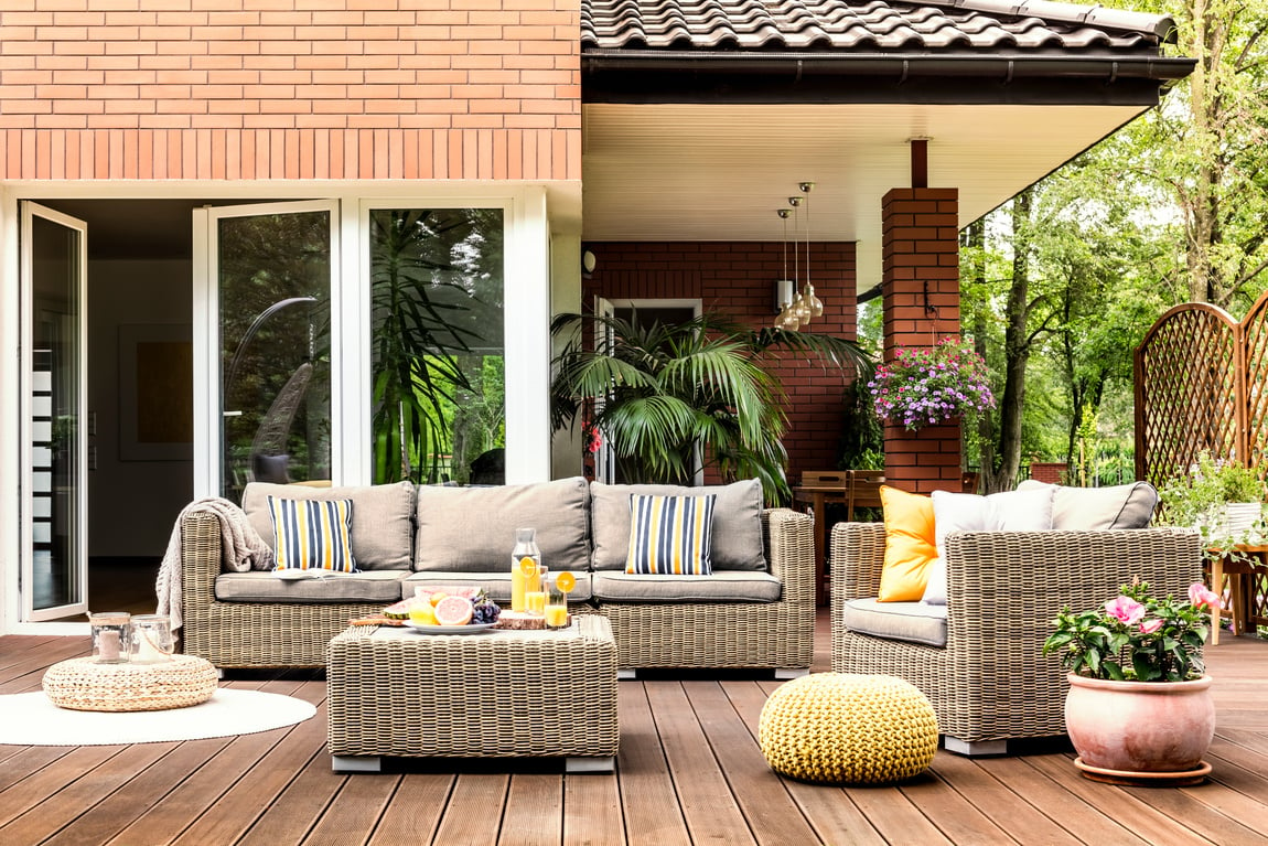 Yellow pouf on wooden patio